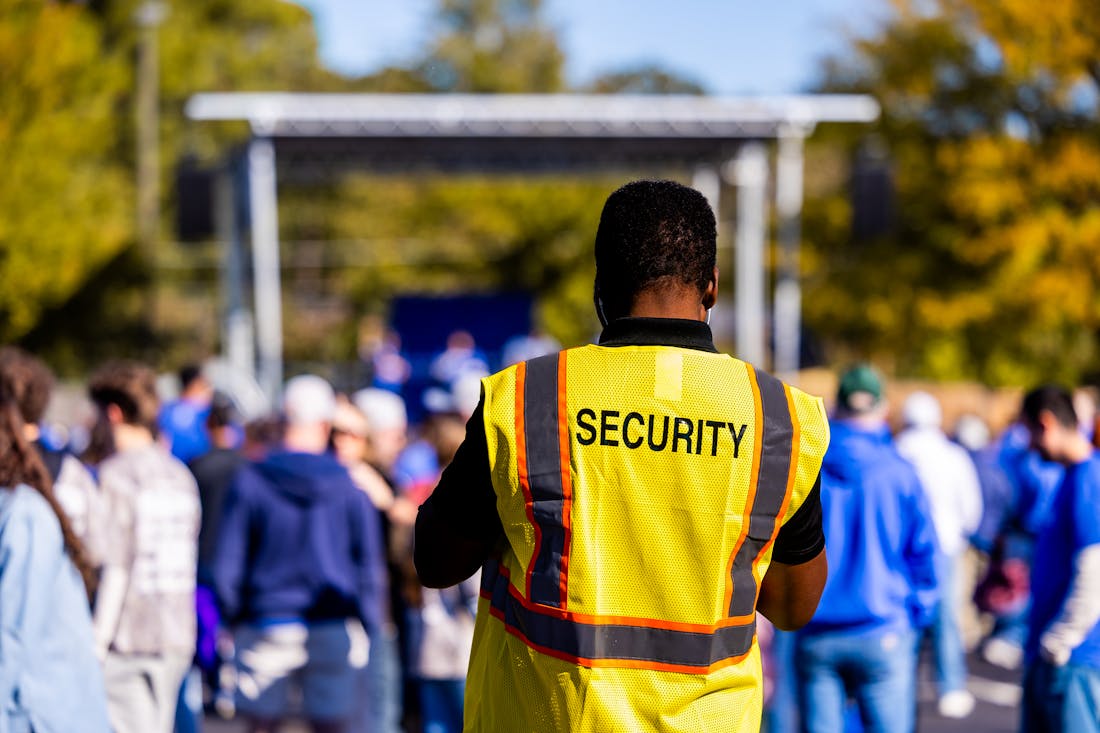 Security staff managing a crowd at an outdoor event